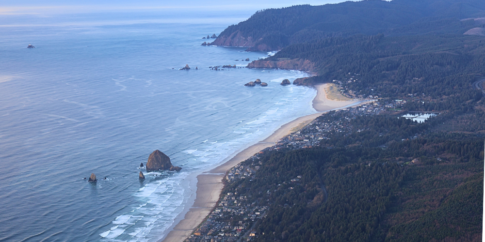 An overhead view of Cannon Beach, including Haystack Rock and Tillamook Head.
